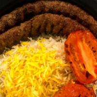 Koobideh Kabob · Two skewers of seasoned ground beef mixed with onion, saffron rice, grill tomato.