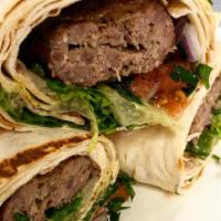 Koobideh kabob roll · one skewer of seasoned ground beef mixed with onion, onion mixed with parsley and sumac, tom...