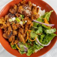 Spicy Pork · Pork cooked in a spicy and salty bean paste sauce. Served over half rice/salad with our hous...