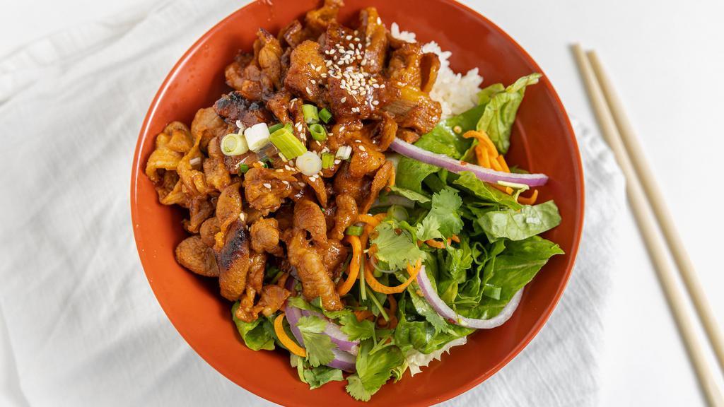 Spicy Pork · Pork cooked in a spicy and salty bean paste sauce. Served over half rice/salad with our house made Asian zing Dressing.