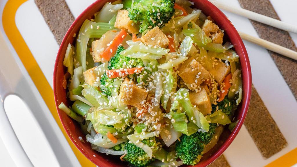 Vegetable Tofu Hot Bowl · Wok-fried mixed greens (cabbage, onion, carrot, celery, broccoli) with lightly fried tofu cubes. Served over rice.