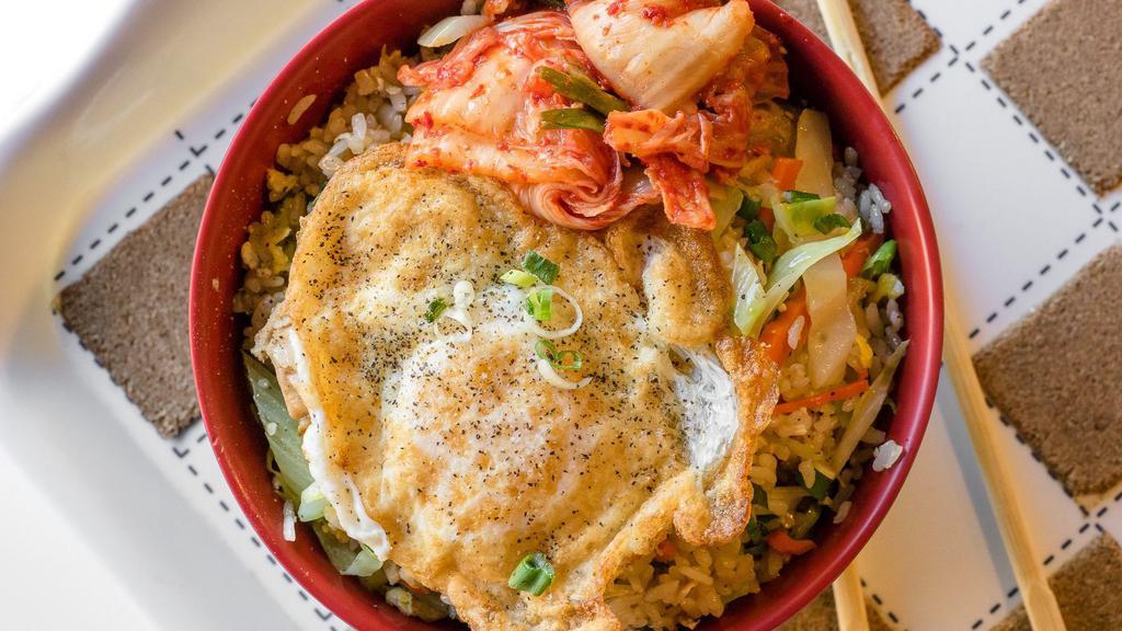 Sun Rice Hot Bowl · Fried rice with chicken, carrots, celery, cabbage, green onions, white onions, and is topped with kimchee and a fried egg.