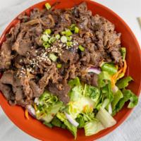 Beef Bulgogi · Rib-eye beef with onions in a sweet tangy Korean Bulgogi Sauce. Served over half rice/salad ...