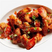 Fried Sriracha Chicken Wings · Six bone-in wings tossed with sriracha, butter, lemon, and cilantro.