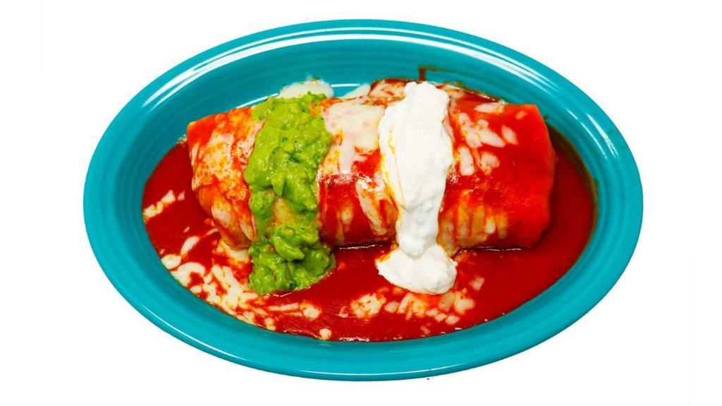 Wet Burrito · Big super burrito (meat, rice, beans, green salsa inside) topped with our homemade enchilada red sauce, cheese, sour cream and guacamole.