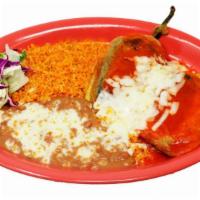 Two Chile Rellenos · Home made pasilla chile stuffed with Monterey cheese, and dipped in egg. Topped with salsa r...