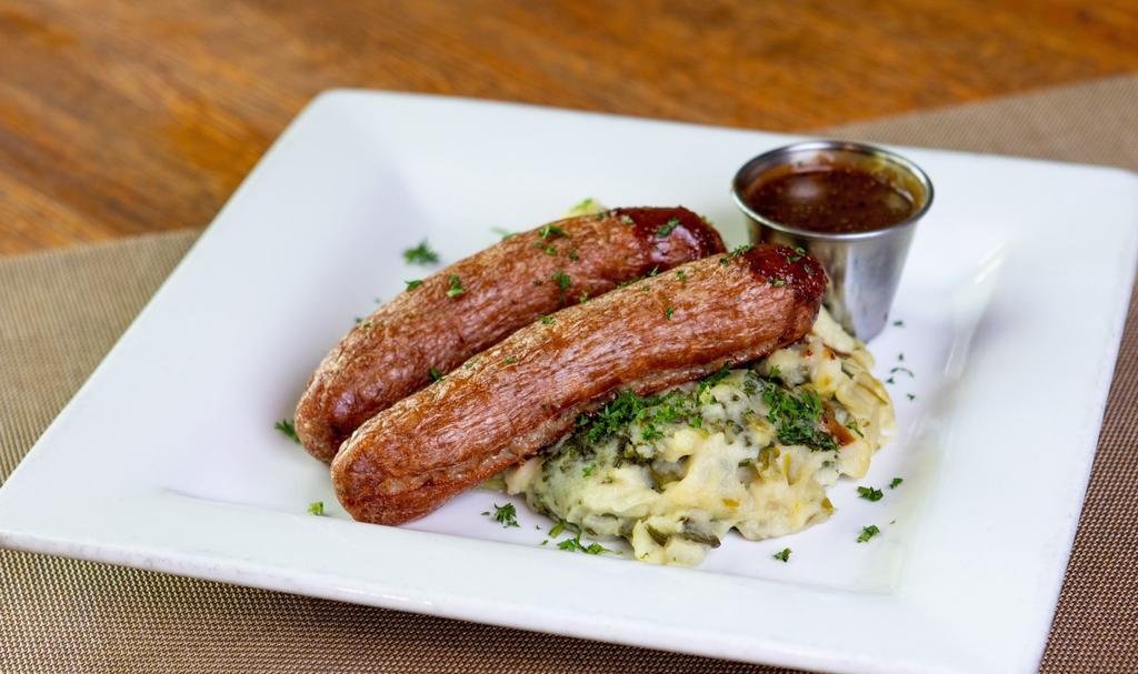 Sausage & Colcannon · Mashed potatoes with braised leeks, kale and onion served with succulent Irish sausages and mustard gravy.
