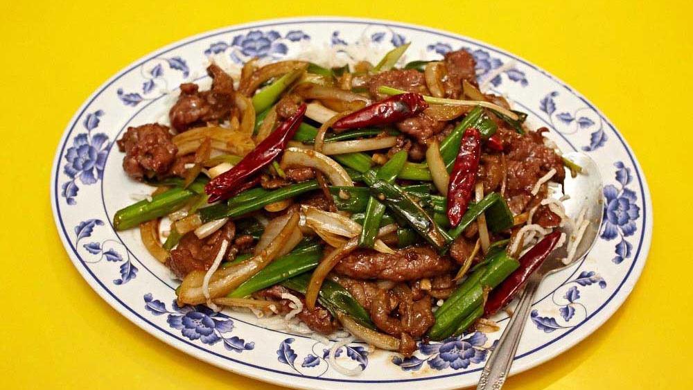 Mongolian Beef
 · Thin slices of beef are cooked with green onions and hot red peppers based with rice noodles.