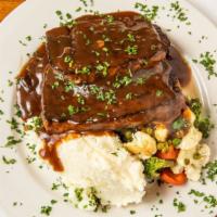 Meatloaf · The ultimate comfort food! Served over mashed potatoes, gravy and seasonal vegetables.
