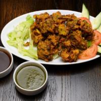 Vegetable Pakora · Special fenugreek spiced fritters along with spinach, onion and potato fritters.