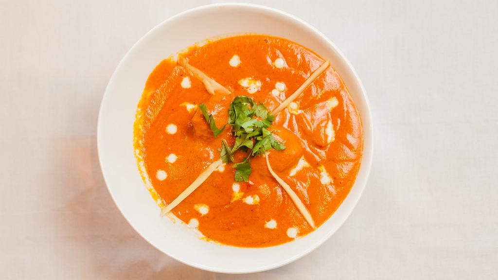 Chicken Tikka Masala · Flavorful and aromatic curry, made with marinated and grilled chicken cubes simmered in a rich onion tomato gravy along with warm spices.