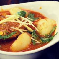 Goat Vindaloo · Curry dish popular in the region of Goa. Traditional Goan dish cooked with potatoes in a fie...