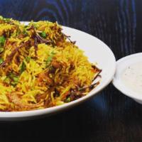 Chicken-Bombay Style Biryani · Long white Basmati rice flavors with saffron and cooked with spiced chicken.