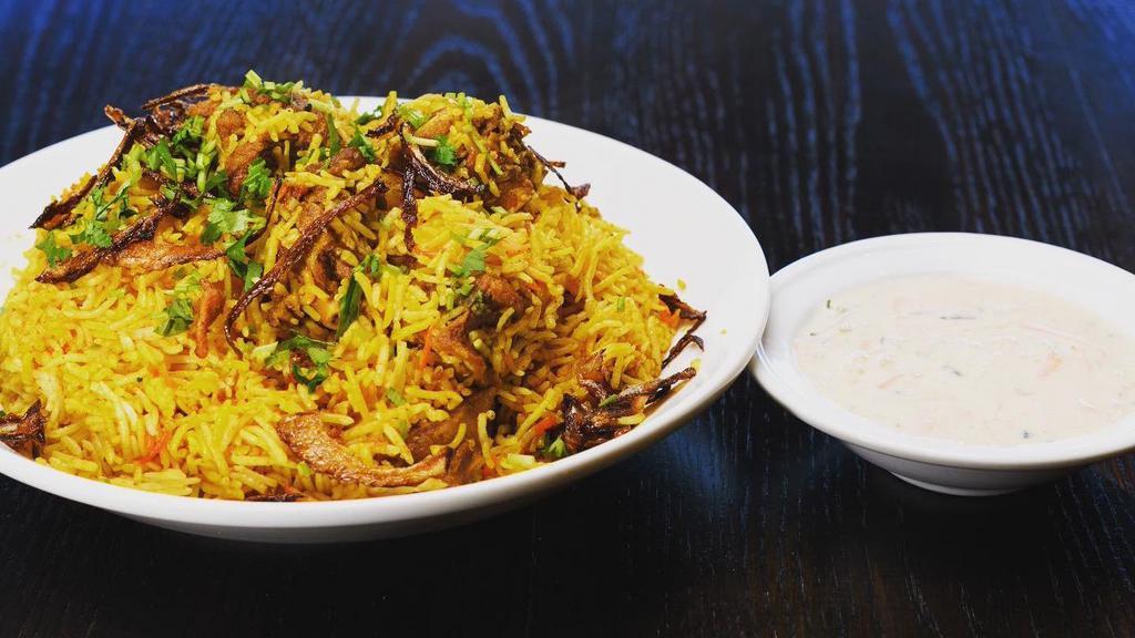 Chicken-Bombay Style Biryani · Long white Basmati rice flavors with saffron and cooked with spiced chicken.
