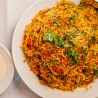 Goat-Sindhi Style Biryani · Long white Basmati rice flavored with saffron and cooked with potato and spiced goat.