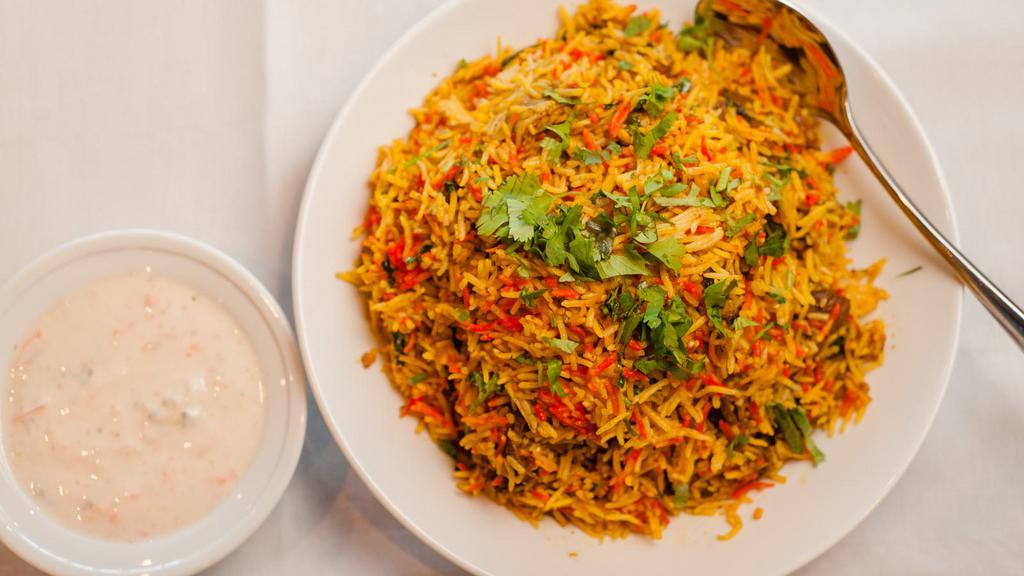 Chicken-Sindhi Style Biryani · Long white Basmati rice flavored with saffron and cooked with potato and spiced chicken.