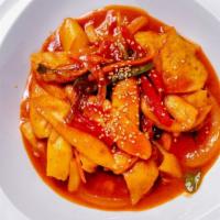 Spicy Rice Cake (Tteokbokki) · Chewy Korean rice cakes in a spicy sauce with fishcakes, onions, carrots, and scallions.