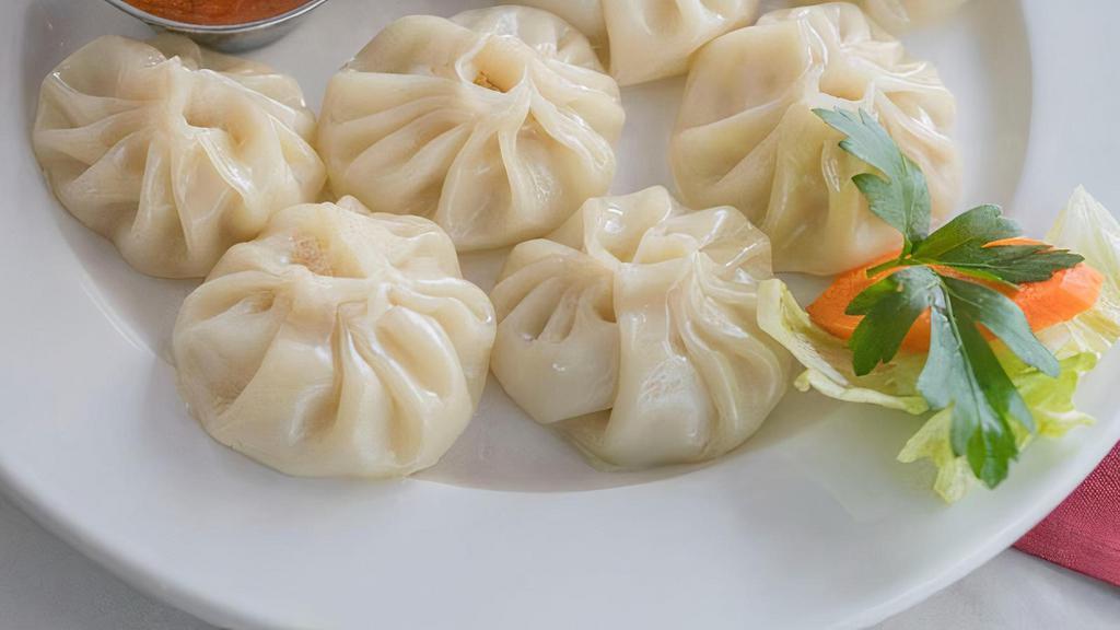 Chicken Momo (5 Dumplings) · Famous Nepalese style steamed chicken dumpling served with tomato and sesame chutney.