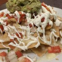 Muchos Nachos · Tortilla chips with refried beans, melted cheese. Pico de gallo. Sour cream and guacamole.