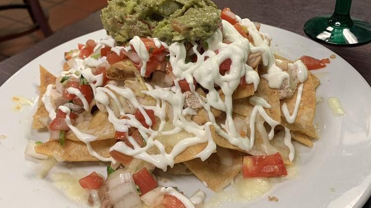 Muchos Nachos · Tortilla chips with refried beans, melted cheese. Pico de gallo. Sour cream and guacamole.
