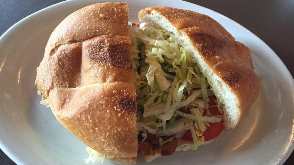Torta · Mexican roll, metled cheese, refried beans, lettuce, tomato, red onion, avocado and choice of meat.