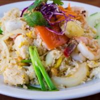Pineapple Fried Rice · Fried rice with chicken, prawns, pineapple, egg, cashews, onions, tomatoes, and sliced of fr...