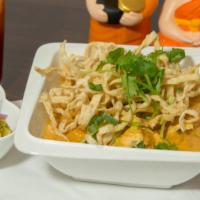 Kao Soy Arawan · Egg noodles in yellow curry with crispy noodles on top served with bean sprouts, red onions,...