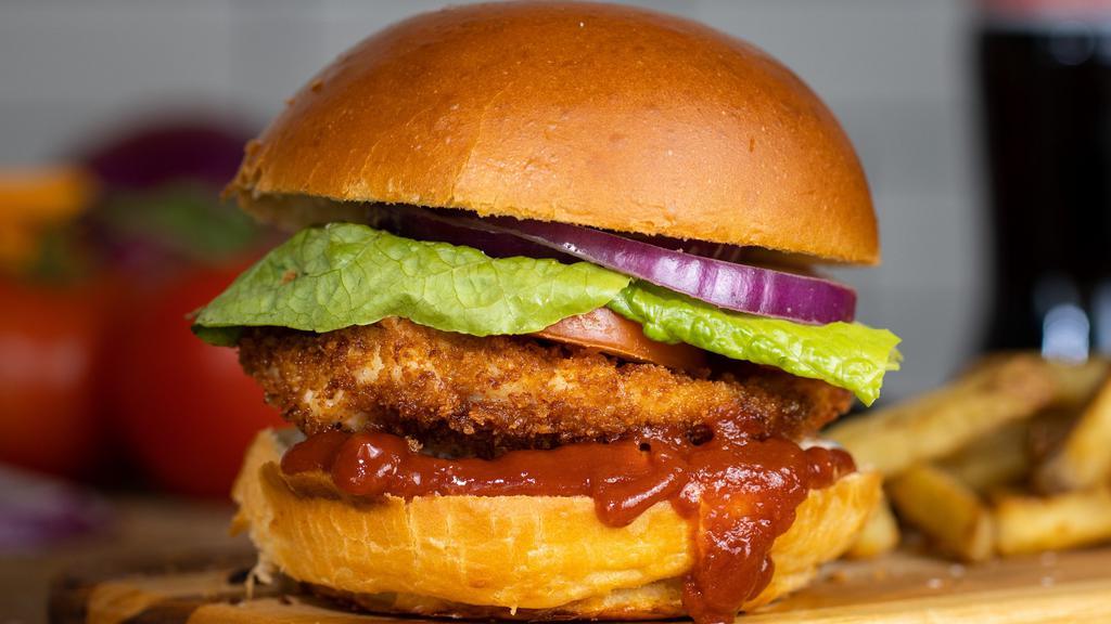 Unbelievaburger · Add a twist to the burger with some crispy fried chicken topped with sliced tomatoes, shredded lettuce, dill pickles, Nashville hot sauce served on a griddled brioche bun.