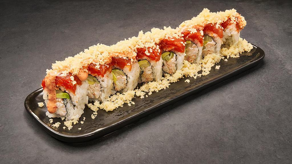 Sunset · House crab, avocado, cucumber, topped with spicy tuna, spicy aioli and tempura flakes. 8 pcs.