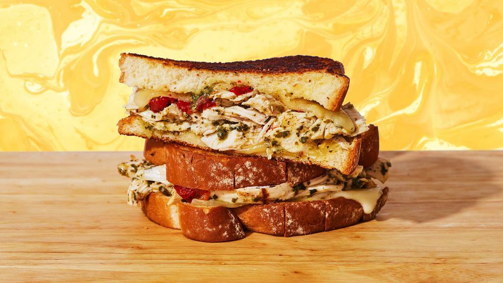 Chicken Pesto Grilled Cheese · This will have you like *kisses fingertips like an Italian chef.* Melty jack and swiss cheese, chicken, savory pesto sauce, and roasted red peppers between two slices of buttery grilled sourdough bread.