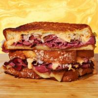 Reuben Grilled Cheese · Meat us in the middle with this sandwich. Melty swiss cheese, juicy pastrami meat, tangy sau...