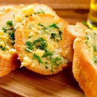 Garlic Bread · House-made half loaf of garlic bread melted with cheese and marinara.