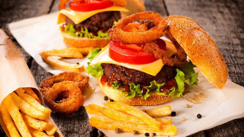 Onion Ring Cheese Burger · Crispy onion ring cheeseburger that includes 1/3 pound beef patty, mild cheddar cheese, deep-fried onion rings, tomatoes, onions, lettuce, mayonnaise, and mustard.