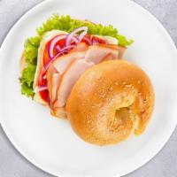 Gobble Trouble Sandwich · Freshly baked bagel Comes with turkey breast, mayo, mustard, lettuce, tomato, cucumbers, oni...