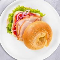 Bagel Street Fighter Club · Freshly baked bagel with Turkey breast, mayo, mustard, lettuce, tomatoes, cucumbers onions, ...