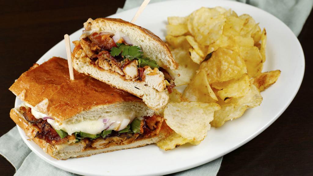 BBQ Chicken Sandwich · Mary's chicken, bbq sauce, cheddar cheese, bacon, red onions, cilantro, green onions, jalapeños, ranch. Served on a toasted French roll with a choice of kettle chips or green salad.