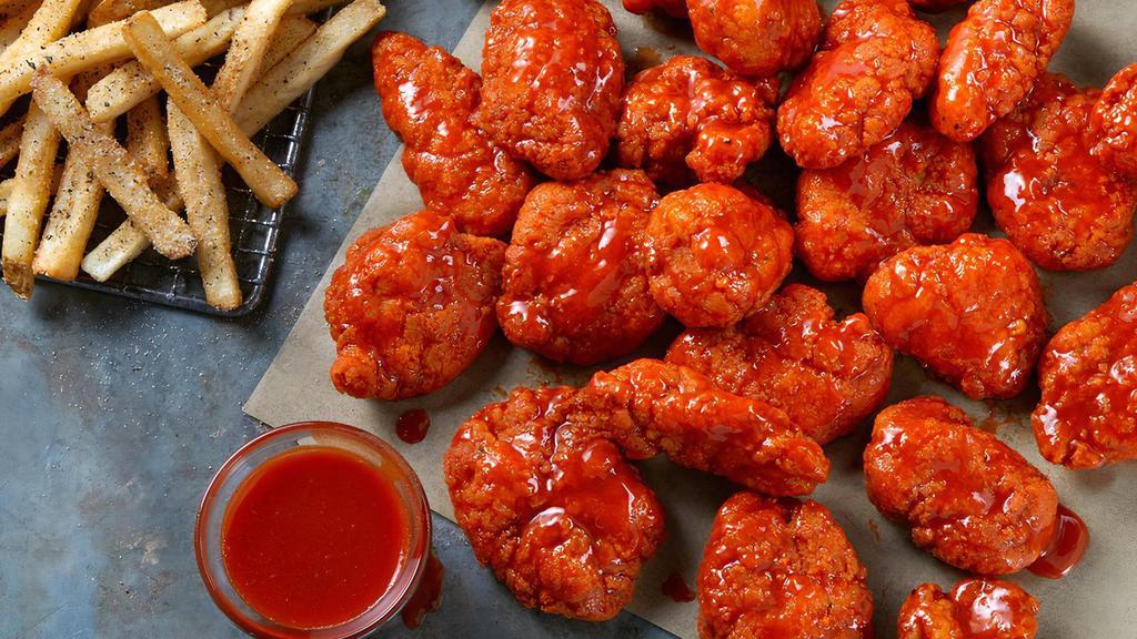 24 Boneless Wings · 24 Boneless Wings tossed in your choice of sauce,  served with seasoned fries and your choice of Ranch or Blue Cheese.