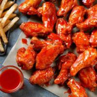 16 Bone-In Wings · 16 Bone-In Wings tossed in your choice of sauce,  served with seasoned fries and your choice...