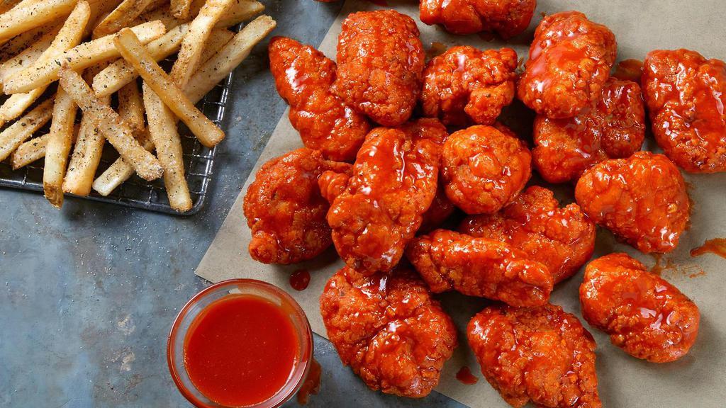 18 Boneless Wings · 18 Boneless Wings tossed in your choice of sauce, served with seasoned fries and your choice of Ranch or Blue Cheese