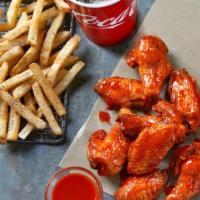Bone-In Wings Combo · 8 Bone-In wings tossed in your choice of sauce,  served with seasoned fries and a Fountain D...