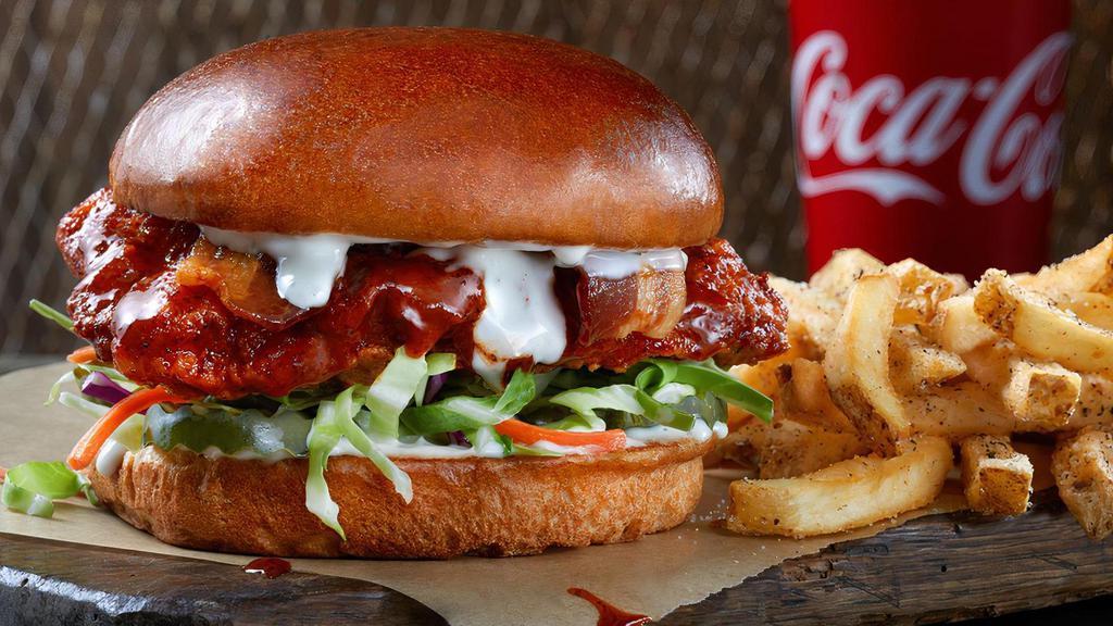 The Fried Spicy Slammer Combo · Chicken breast, crispy golden brown, tossed in Nashville Hot sauce, bacon, Ranch, pickled jalapenos and fresh cabbage mix on a soft challah bun. Served with seasoned fries and a Fountain Drink.