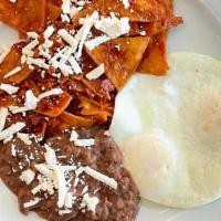 CHILAQUILES · Tortilla chips, spicy red sauce, chorizo, queso fresco, two eggs any style*, avocado, crema,...