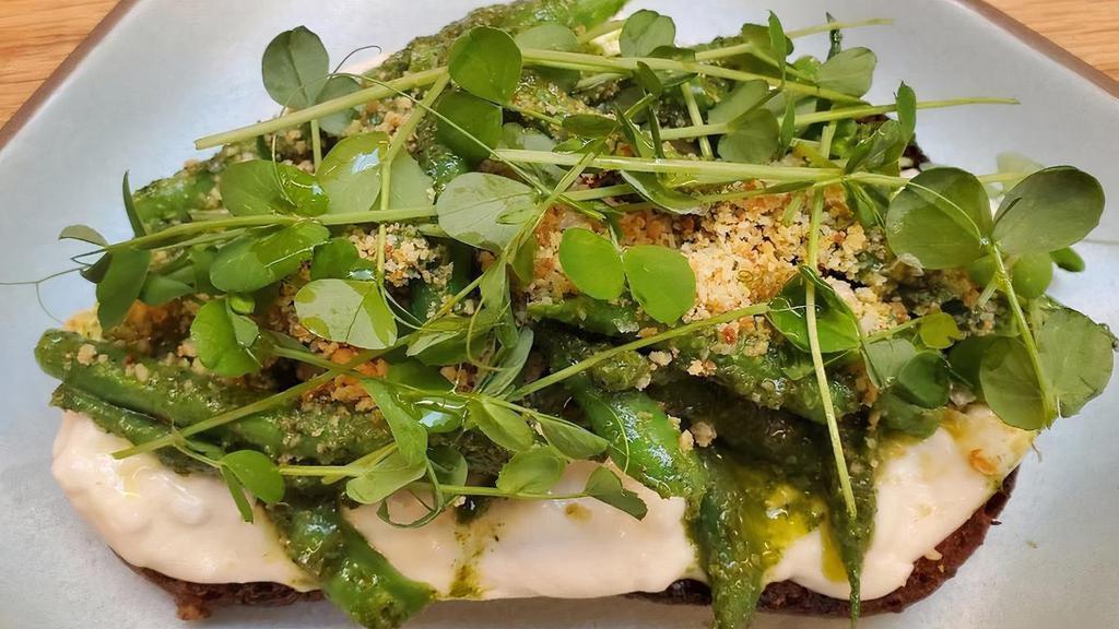 GREEN BEAN & BURRATA TARTINE · farmers' market green beans on creamy burrata with spicy green sauce, green garlic crumble, and pea shoots (sauce made from carrot greens, serrano chile, garlic, cardamom, and pomegranate molasses)