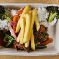Lomo or Pollo Saltado · Stir-fried beef tender-loin with onions, tomatoes, gluten-free soy sauce, and fries.