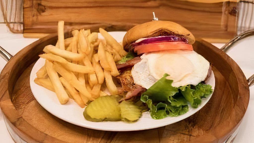 Ghost Garbage Grinder Burger Meal · 6 oz angus ground chuck burger topped with thick-cut turkey bacon, cheddar cheese and fried egg served with French fries.