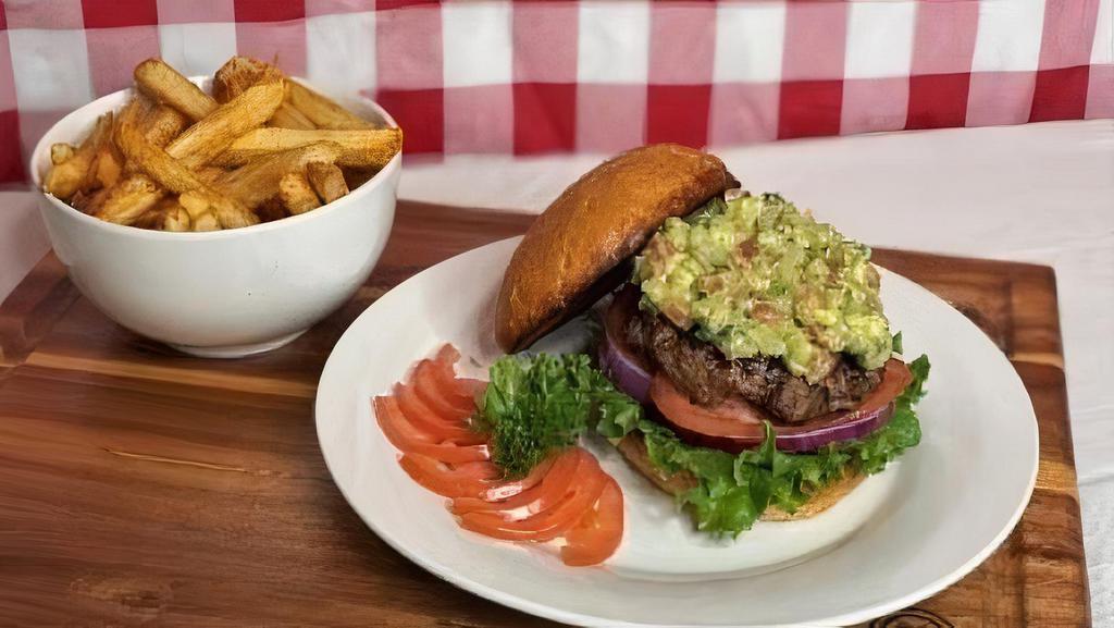 Guacamole Burger Meal · Six oz seasoned angus beef patty on a toasted bun topped with guacamole lettuce tomatoes and onions served with French fries.
