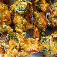 Spinach Pakora · Spinach dipped in chick pea batter and deep fried.