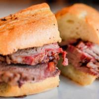 The Tri Tip · Sliced tri tip, garlic butter, french roll.