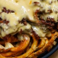 CHILI-CHEESE FRIES · Curly fries, grass-fed beef chili, triple-cheese sauce.