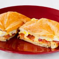 Croissant Breakfast Sandwich · Croissant with two eggs, cheese and choice of meat.Choice of bacon, ham or sausage
